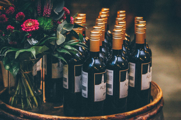 Wine bottles and a floral arrangement set up for a function